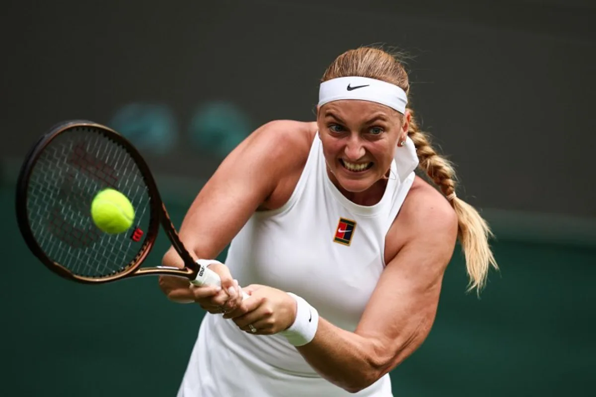 Czech Republic's Petra Kvitova returns the ball to US player Emma Navarro during their women's singles first round tennis match on the second day of the 2025 Wimbledon Championships at The All England Lawn Tennis and Croquet Club in Wimbledon, southwest London, on July 1, 2025. HENRY NICHOLLS / AFP