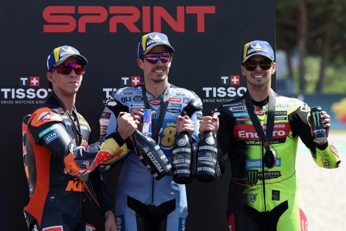(From L) Team Red Bull KTM Factory Racing's Pedro Acosta, Team Gresini Racing MotoGP's Alex Marquez and Team Pertamina Enduro VR46 Racing Team's Fabio Di Giannantonio celebrate on the podium after the Sprint Race at the Catalunya Moto GP Grand Prix at the Catalunya racetrack in Montmelo, near Barcelona, on May 16, 2026.  Lluis GENE / AFP