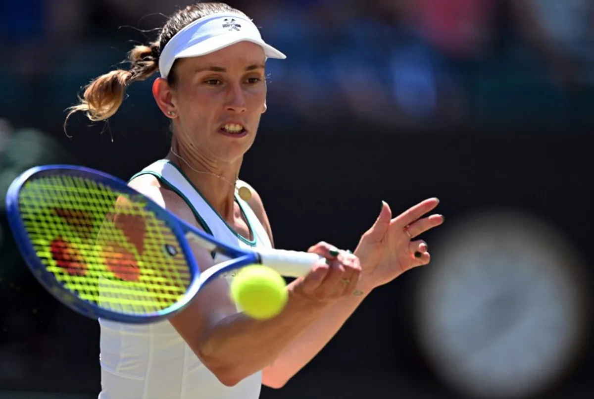 Belgium's Elise Mertens returns to Czech Republic's Linda Noskova during their women's singles quarter-final tennis match on the tenth day of the 2026 Wimbledon Championships at The All England Lawn Tennis and Croquet Club in Wimbledon, southwest London, on July 8, 2026. Kirill KUDRYAVTSEV / AFP