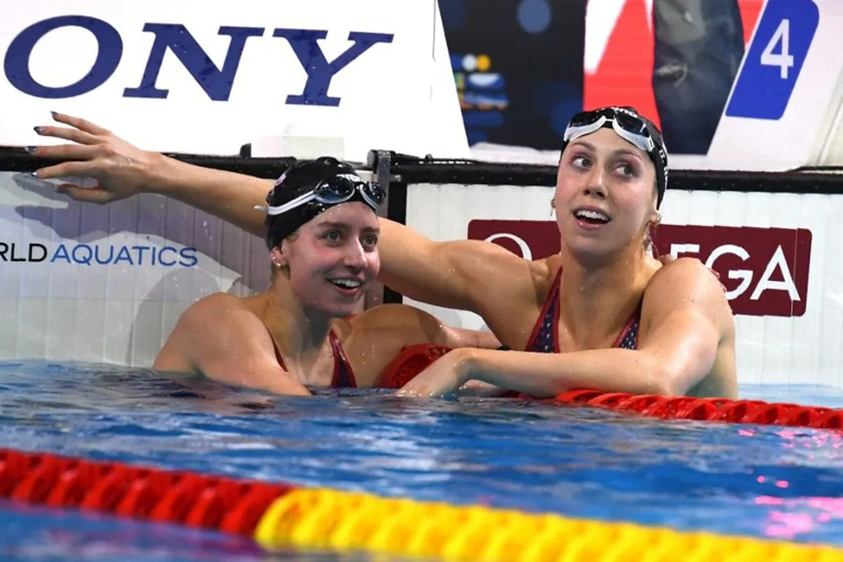 US Gretchen Walsh (R) reacts after winning the Women's Individual 100m Medley final during the World Aquatics Swimming Championships (25 m) 2024 at Duna Arena in Budapest, on December 13, 2024.   Ferenc ISZA / AFP