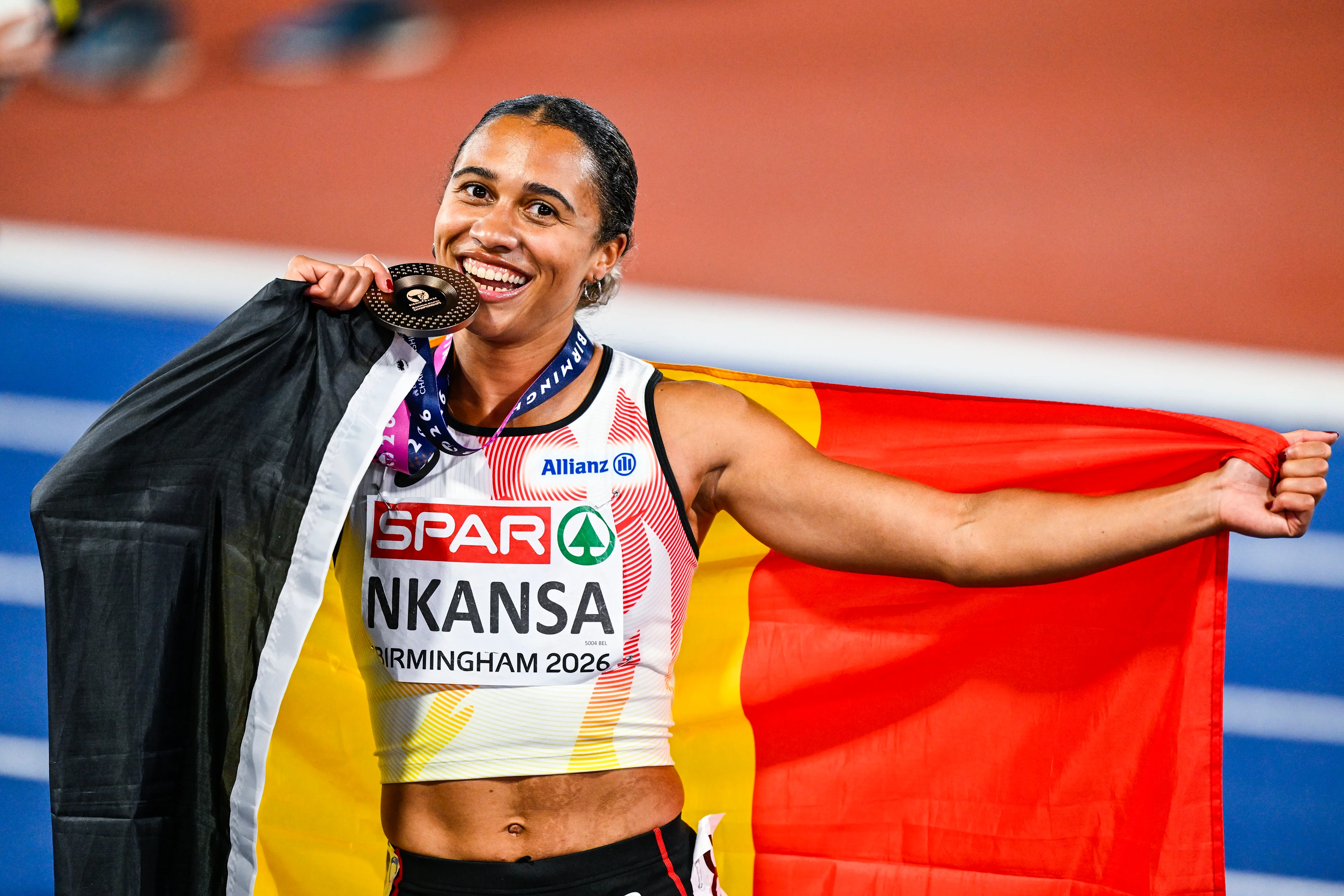 Belgian Delphine Nkansa celebrates with her bronze medal and the Belgian flag after the final of the women's 100m race at the European Athletics Championships (August 10-18) in Birmingham, United Kingdom, on Monday 10 August 2026. BELGA PHOTO ERIC LALMAND