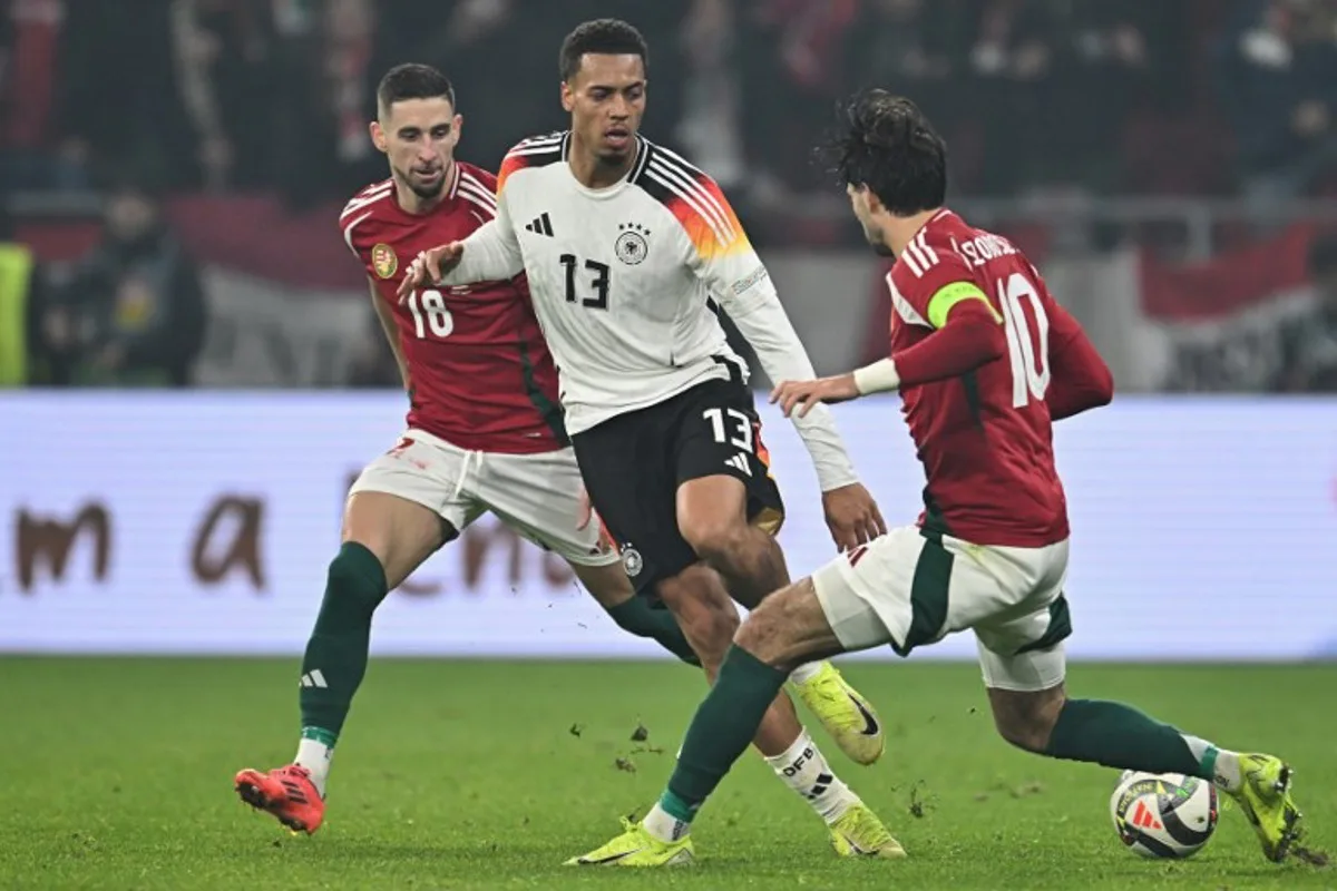 Germany's midfielder #13 Felix Nmecha (C), Hungary's midfielder #10 Dominik Szoboszlai (R) and Hungary's midfielder #18 Zsolt Nagy vie for the ball during the UEFA Nations League Group A3 football match Hungary vs Germany at the Puskas Arena in Budapest, Hungary, on November 19, 2024.  Attila KISBENEDEK / AFP