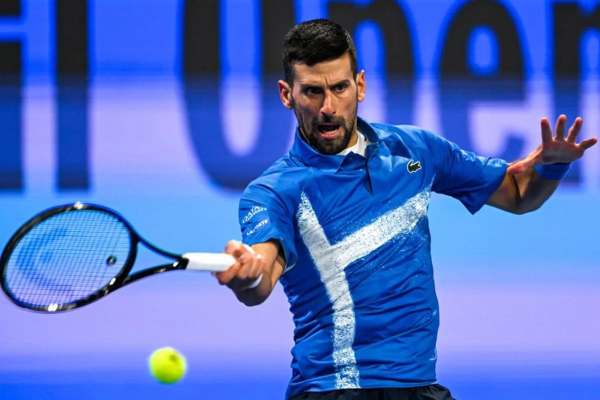 Serbia's Novak Djokovic hits a return to Italy's Matteo Berettini during their men's singles match at the ATP Qatar Open tennis tournament in Doha on February 18, 2025.  Mahmud HAMS / AFP