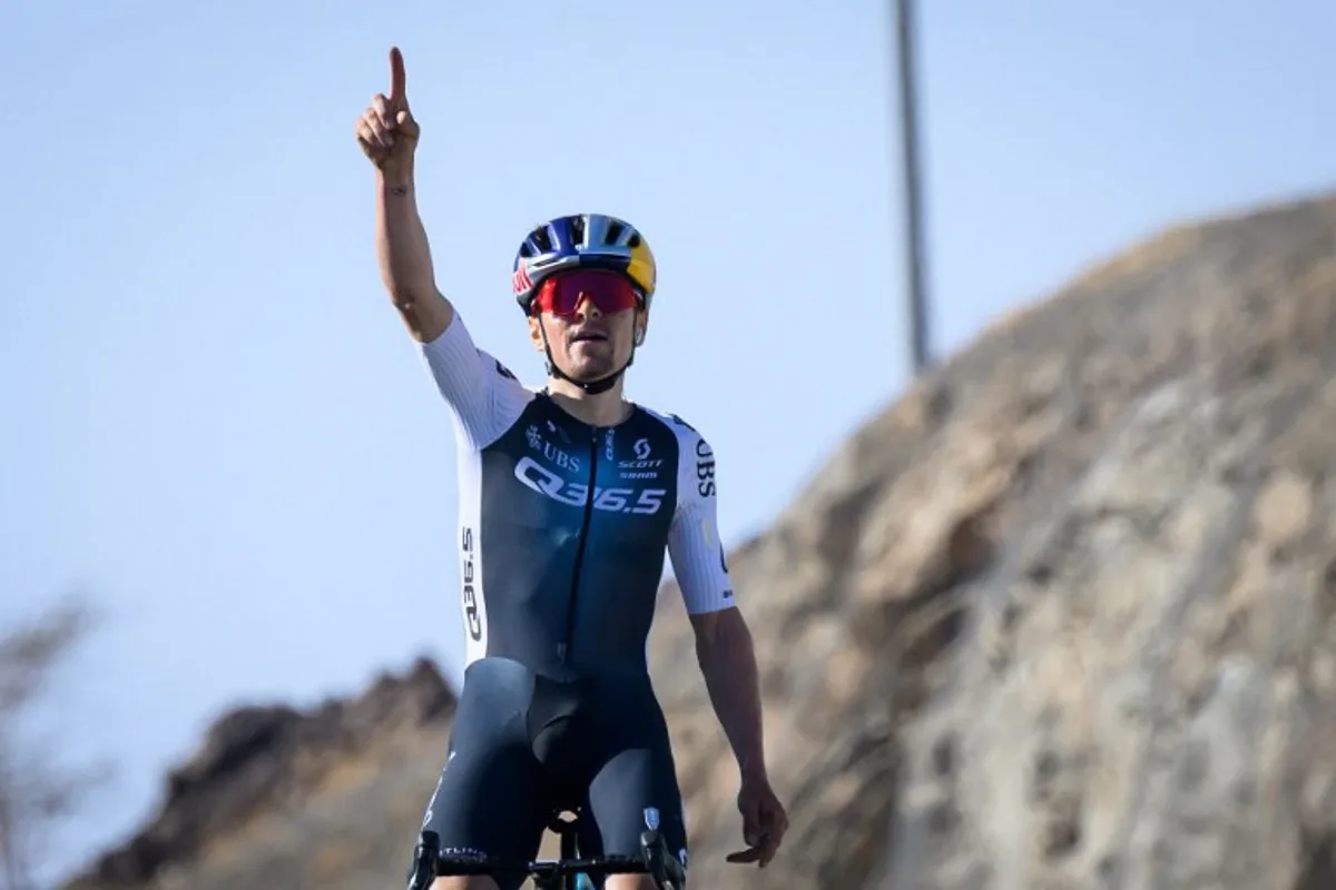 Team Q36.5 Pro Cycling Team's British rider Tom Pidcock celebrates as he crosses the finish line to win the second stage of the AlUla Tour cycling race, 158 km from Allula Old Town to Bir Jaydah Mountain Wirkah, on January 29, 2025.  Loic VENANCE / AFP