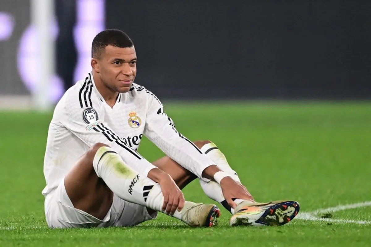 Real Madrid's French forward #09 Kylian Mbappe reacts after an injury during the UEFA Champions League football match between Atalanta and Real Madrid at the Gewiss Stadium in Bergamo, on December 10, 2024.  Marco BERTORELLO / AFP