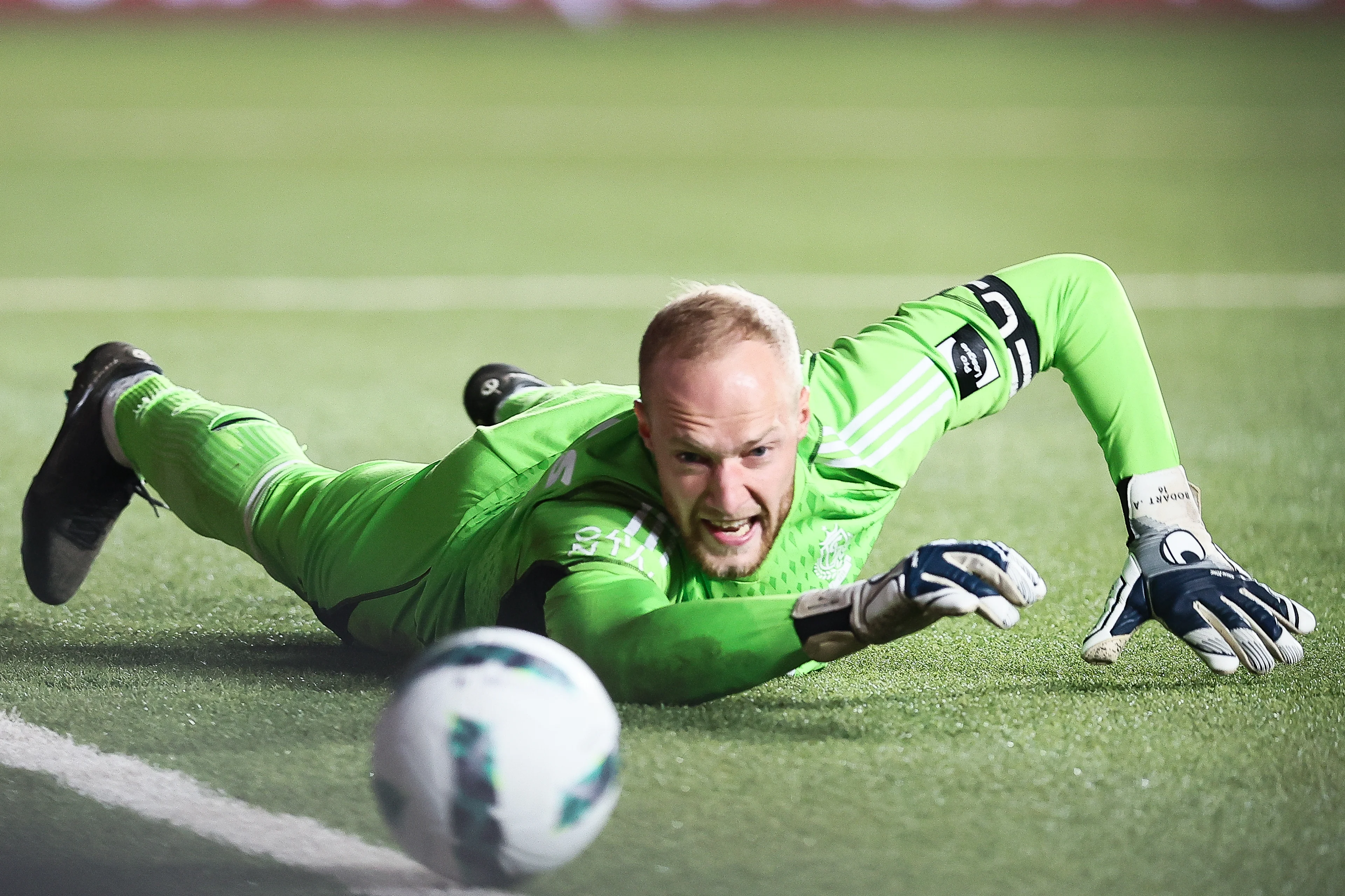 Standard's goalkeeper Arnaud Bodart stops the ball during a soccer match between Sint-Truidense VV and Standard de Liege, Friday 12 April 2024 in Sint-Truiden, on day 3 (out of 10) of the Europe Play-offs of the 2023-2024 'Jupiler Pro League' first division of the Belgian championship. BELGA PHOTO BRUNO FAHY