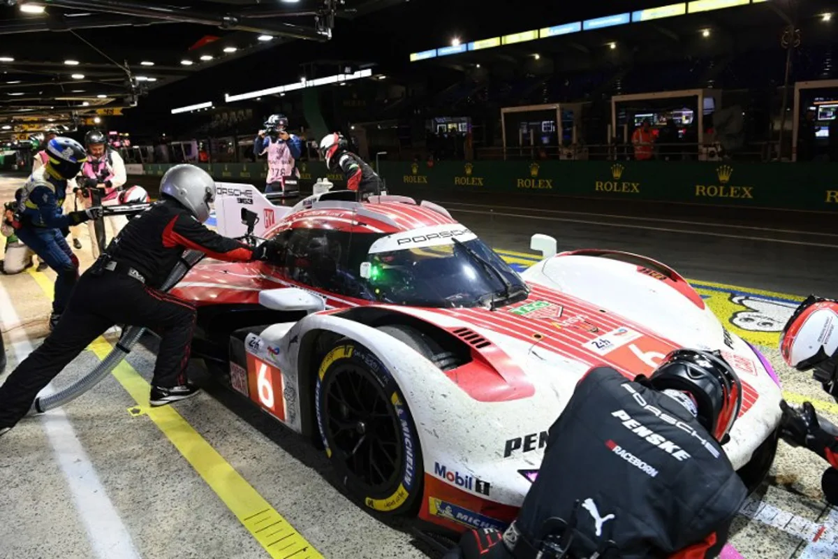 Porsche Penske Motorsport Thor Team's hypercar # 06 Belgian driver Laurens Vanthoor refuels in their pit during the 2025 Le Mans 24 hour endurance race, at the Le Mans circuit, in northwestern France, on June 15, 2025. JEAN-FRANCOIS MONIER / AFP