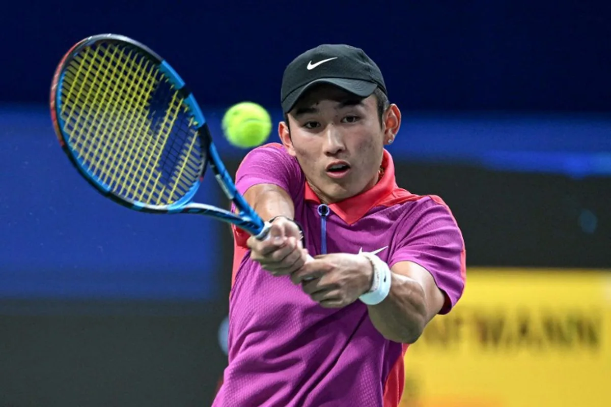 China's Shang Juncheng hits a return against Germany's Yannick Hanfmann during their men's singles semifinal match at the ATP Chengdu Open tennis tournament in Chengdu, in China's southwestern Sichuan province on September 23, 2024.  AFP