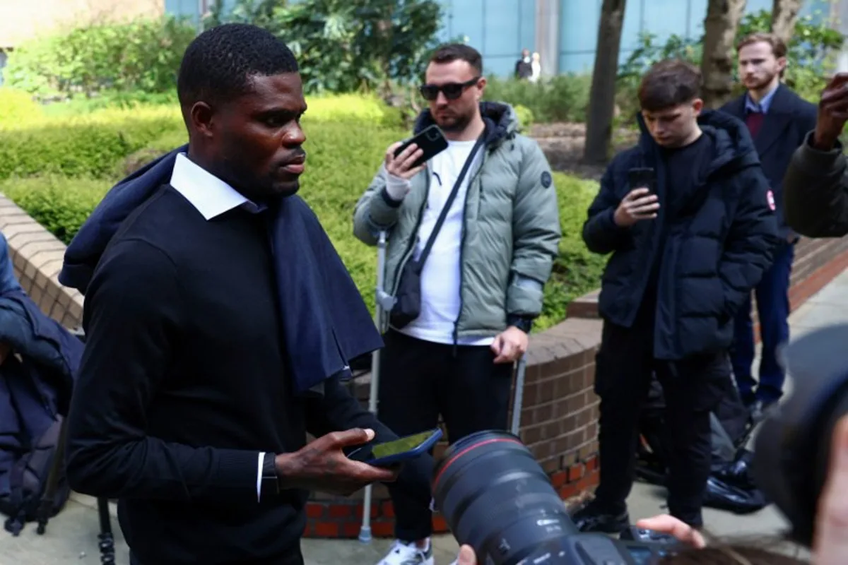 Former Arsenal midfielder Thomas Partey departs following his hearing at the Southwark Crown Court in London on April 13, 2026. Partey, who now plays for Spanish club Villarreal, was charged in February with two further counts of rape. Toby Shepheard / AFP