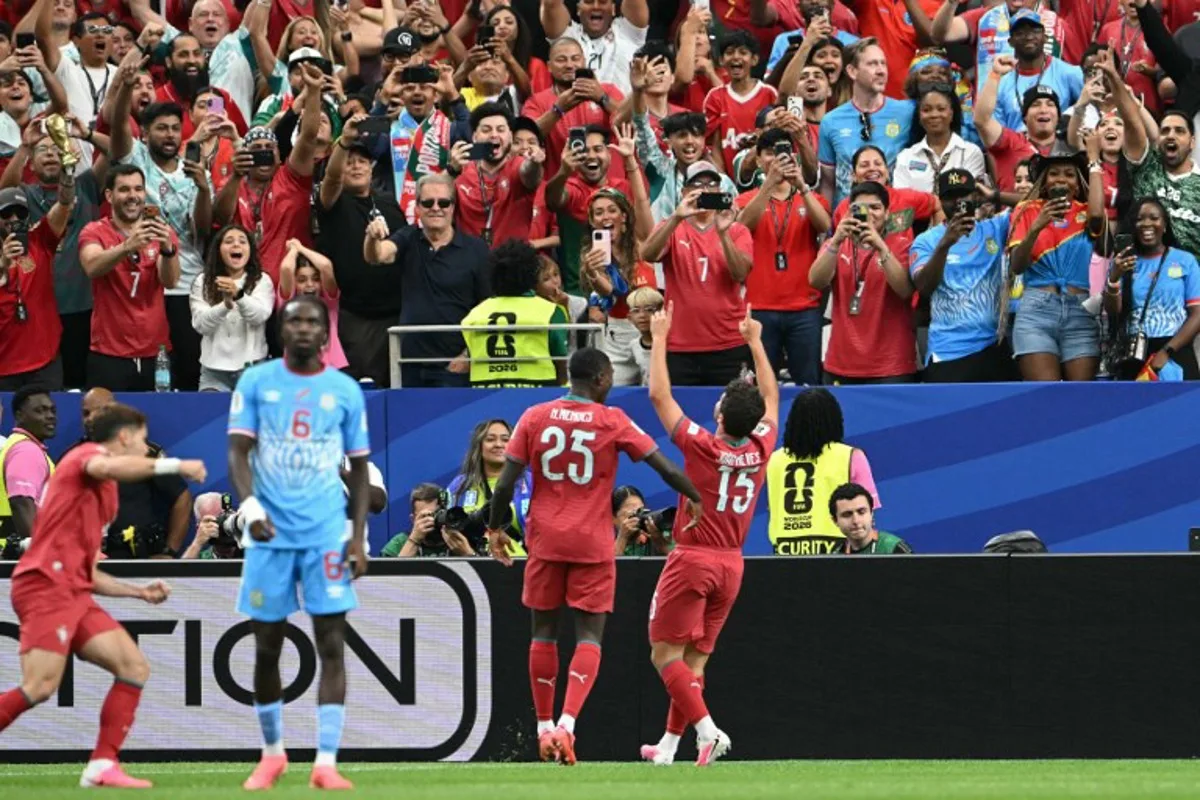 Portugal's midfielder #15 Joao Neves (R) celebrates after scoring the opening goal during the 2026 World Cup Group K football match between Portugal and the Democratic Republic of Congo at the Houston Stadium in Houston on June 17, 2026. RONALDO SCHEMIDT / AFP