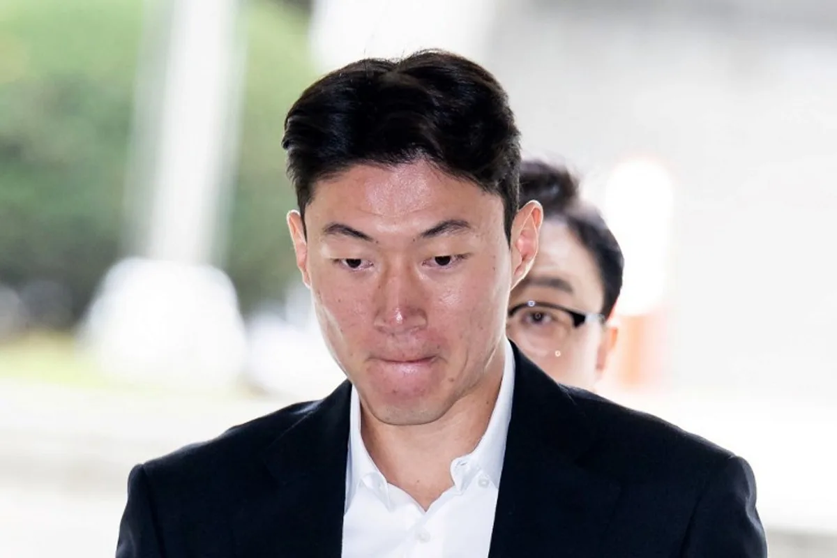 This picture taken on October 16, 2024 shows South Korean footballer Hwang Ui-jo arriving for his trial at the Seoul Central District Court in Seoul as he is accused of secretly recording himself having sex with women without their consent using his phone. Footballer Hwang Ui-jo admitted illegally filming sexual encounters but pleaded for leniency, with the South Korean striker facing a possible four-year jail term, a trial transcript showed on October 17. YONHAP / AFP