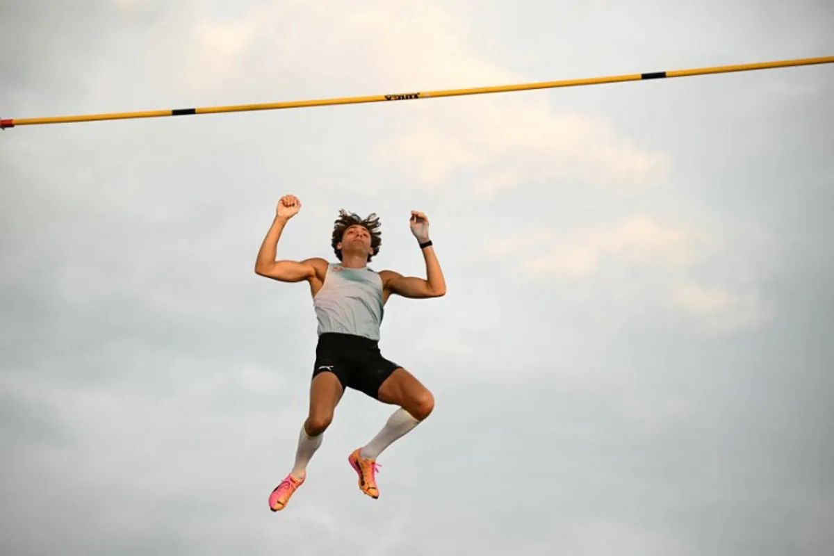 Sweden's Armand Duplantis clears the bar as he competes in the men's Pole Vault during the World Athletics Diamond League athletics meeting at the Stade Olympique de la Pontaise in Lausanne, on August 20, 2026.  Fabrice COFFRINI / AFP