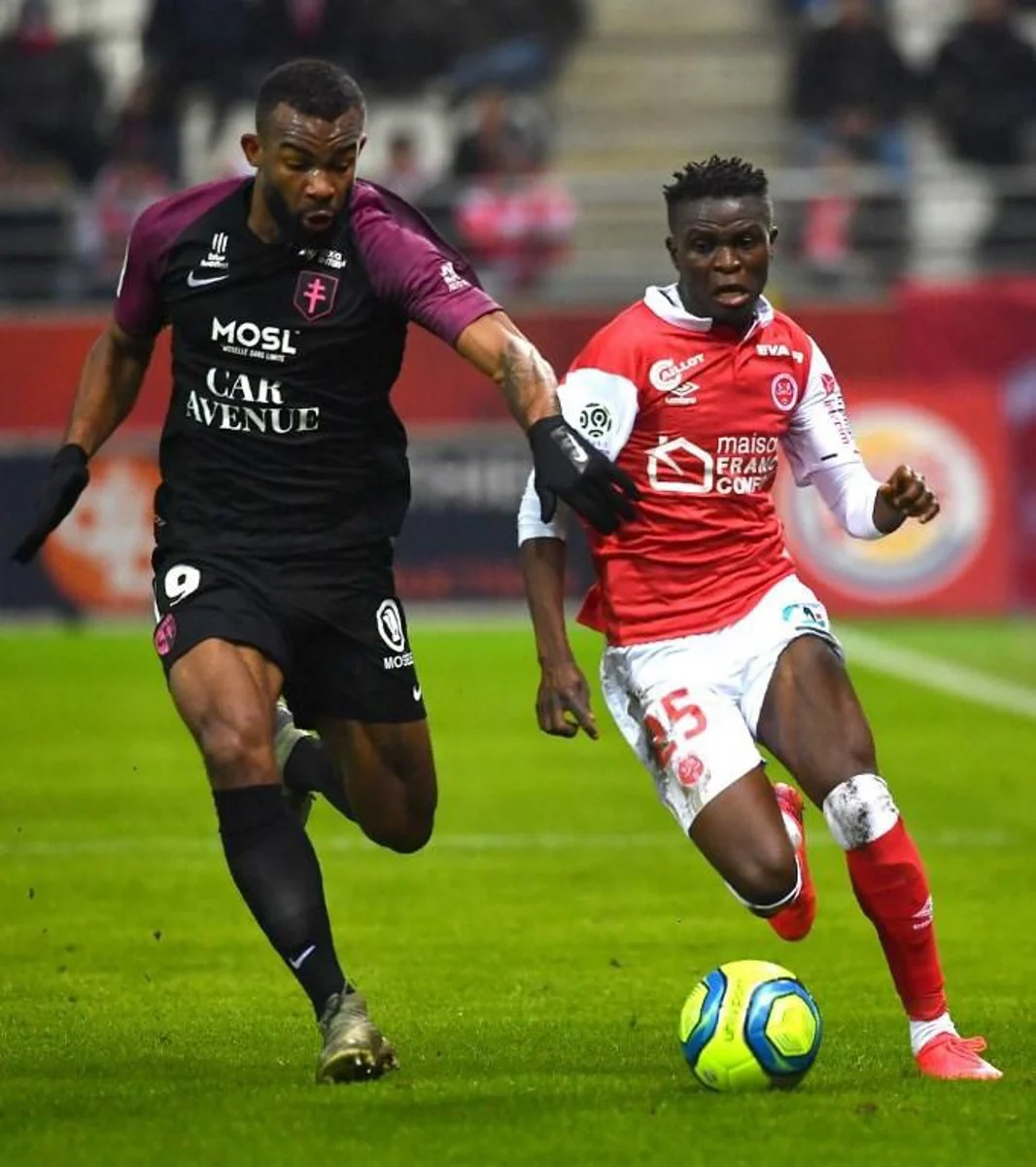Reims' French forward Timothe Nkada (L) vies with Reims' Malian midfielder Moussa Doumbia during the French L1 football match between Stade de Reims and FC Metz at the Auguste Delaune Stadium in Reims, northeastern France on January 25, 2020. DENIS CHARLET / AFP