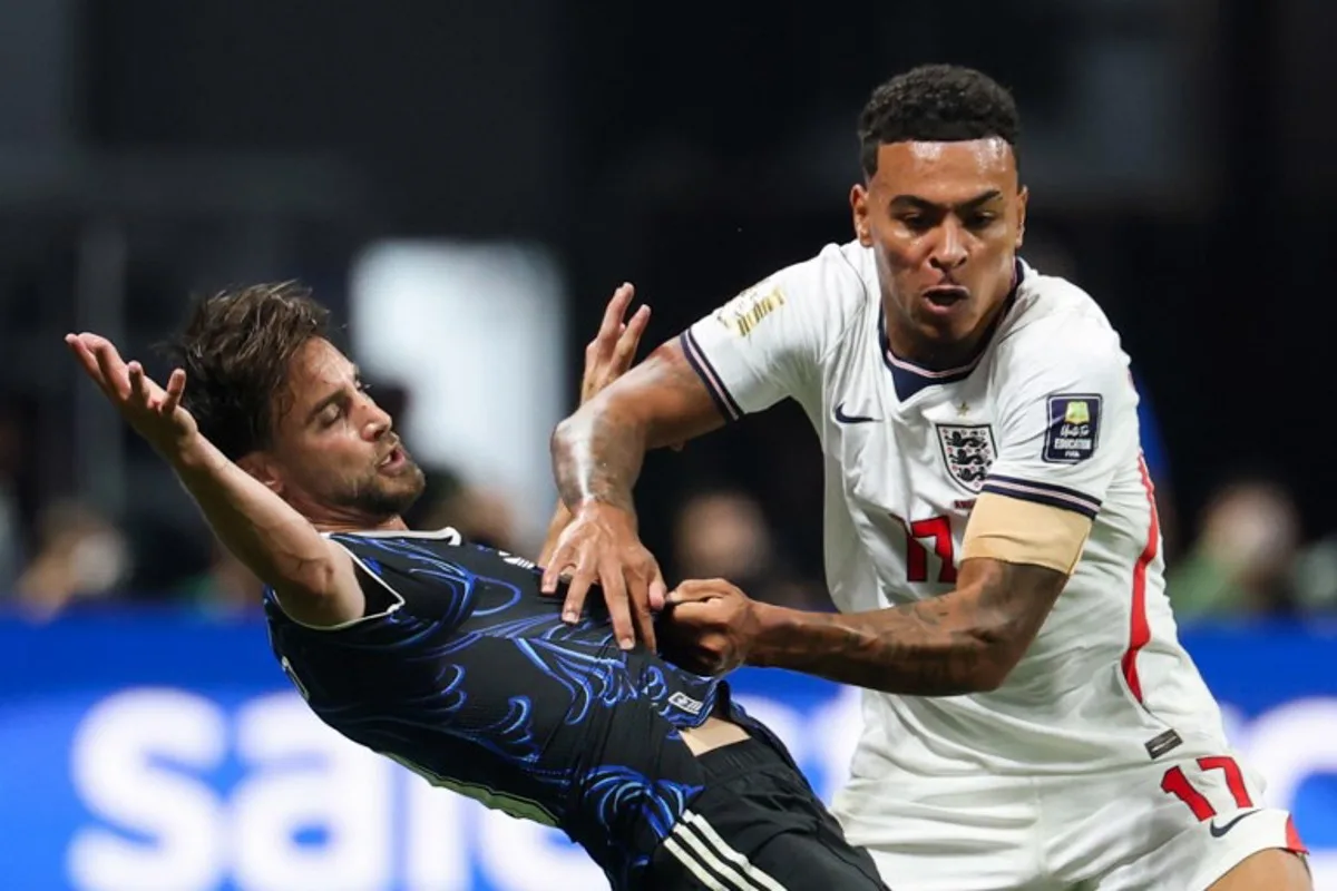 England's midfielder #17 Morgan Rogers (R) and Argentina's defender #03 Nicolas Tagliafico fight for the ball during the 2026 World Cup football tournament semi-final match between England and Argentina at the Atlanta Stadium in Atlanta on July 15, 2026. Odd ANDERSEN / AFP