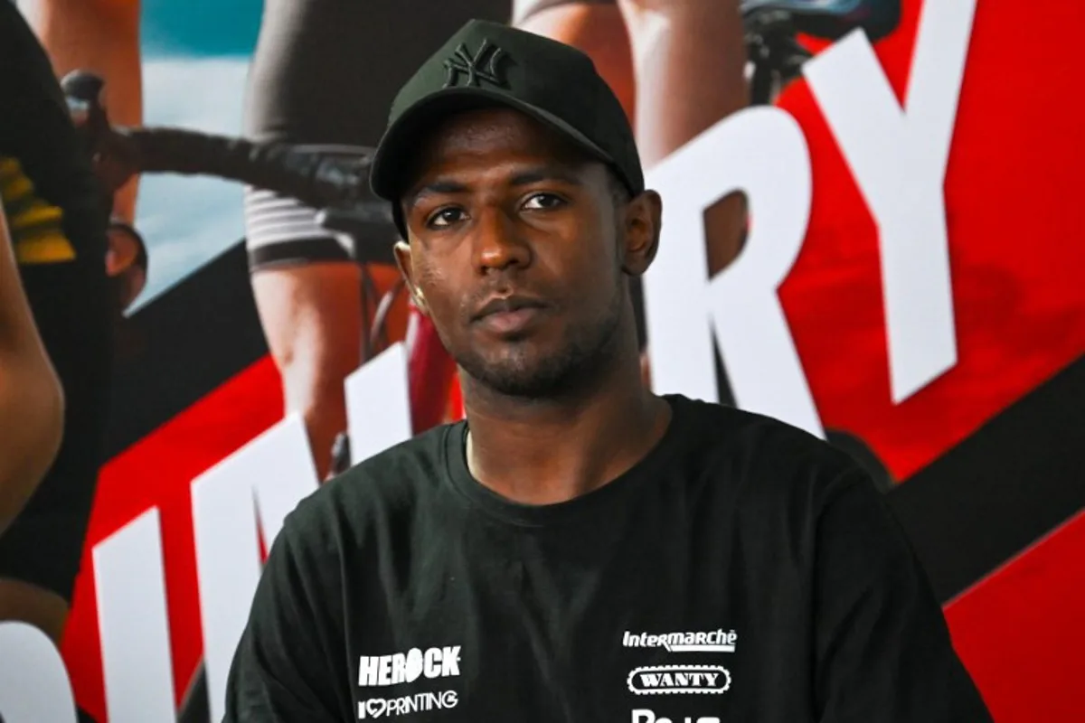 Eritrean cyclist Biniam Girmay attends a press conference ahead of the third Tour de France Singapore Criterium race in Singapore on November 9, 2024.  Roslan RAHMAN / AFP