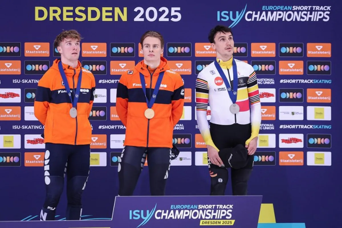 (L-R) Second placed Netherlands's Sven Roes #132, first placed Netherlands's Jens van't Wout #13 and third-placed Belgium's Stijn Desmet #08 stand during the medal ceremony of the men's 1500m event on Day 2 of the ISU European short track speed skating Championships in Dresden, eastern Germany, on January 18, 2025.  Ronny HARTMANN / AFP