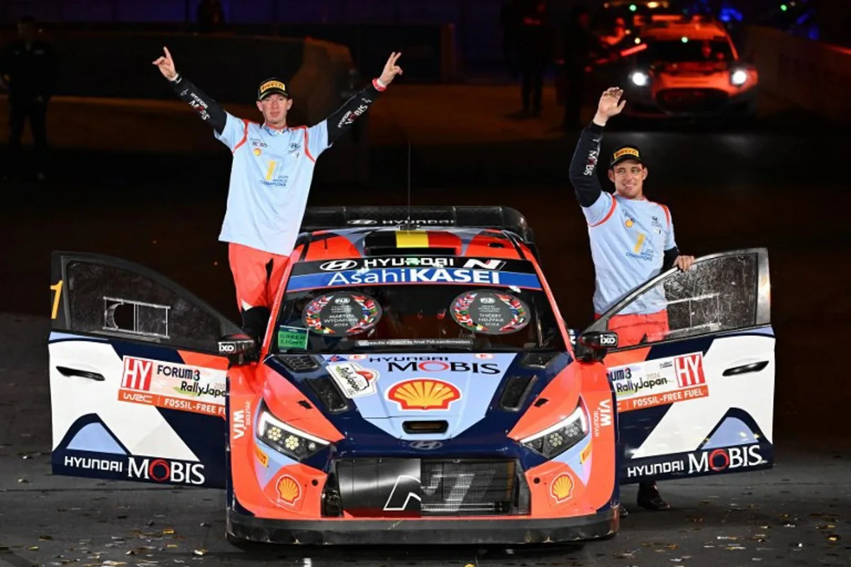 Thierry Neuville (R) and his co-driver Martijn Wydaeghe (L) of Belgium celebrate their World Champion on the podium at the Toyota stadium during the Rally Japan, the 13th and final round of 2024 FIA World Rally Championships, in Toyota city on November 24, 2024.   Toshifumi KITAMURA / AFP