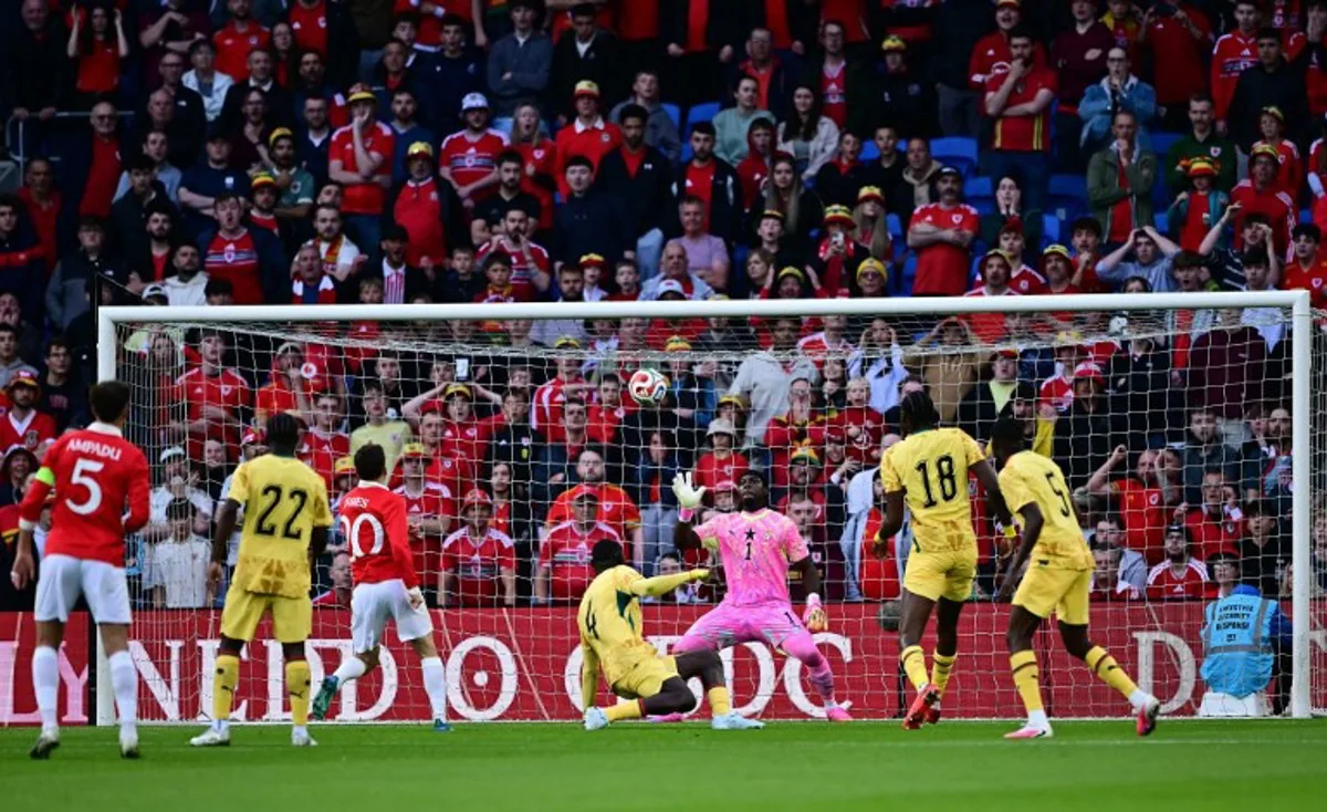 Ghana's goalkeeper #01 Lawrence Ati-Zigi saves a shot from Wales' midfielder #20 Daniel James during the international friendly football match between Wales and Ghana ahead of the 2026 FIFA World Cup football tournament, at Cardiff City Stadium, in Cardiff, on June 2, 2026. Ben STANSALL / AFP