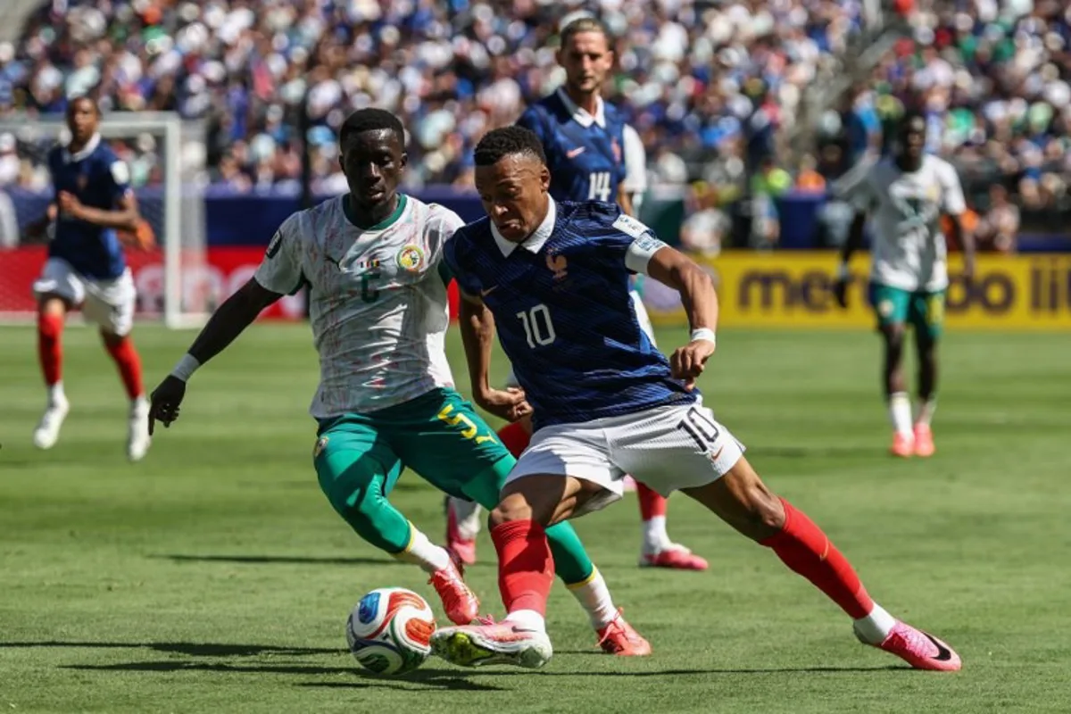France's forward #10 Kylian Mbappe and Senegal's midfielder #05 Idrissa Gana Gueye fight for the ball during the 2026 World Cup Group I football match between France and Senegal at the New York/New Jersey Stadium in East Rutherford on June 16, 2026. FRANCK FIFE / AFP