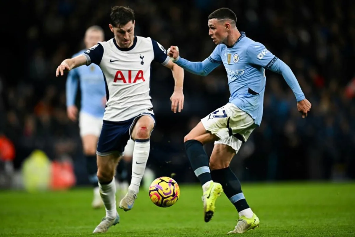 Manchester City's English midfielder #47 Phil Foden (R) shoots the ball during the English Premier League football match between Manchester City and Tottenham Hotspur at the Etihad Stadium in Manchester, north west England, on November 23, 2024.  Paul ELLIS / AFP