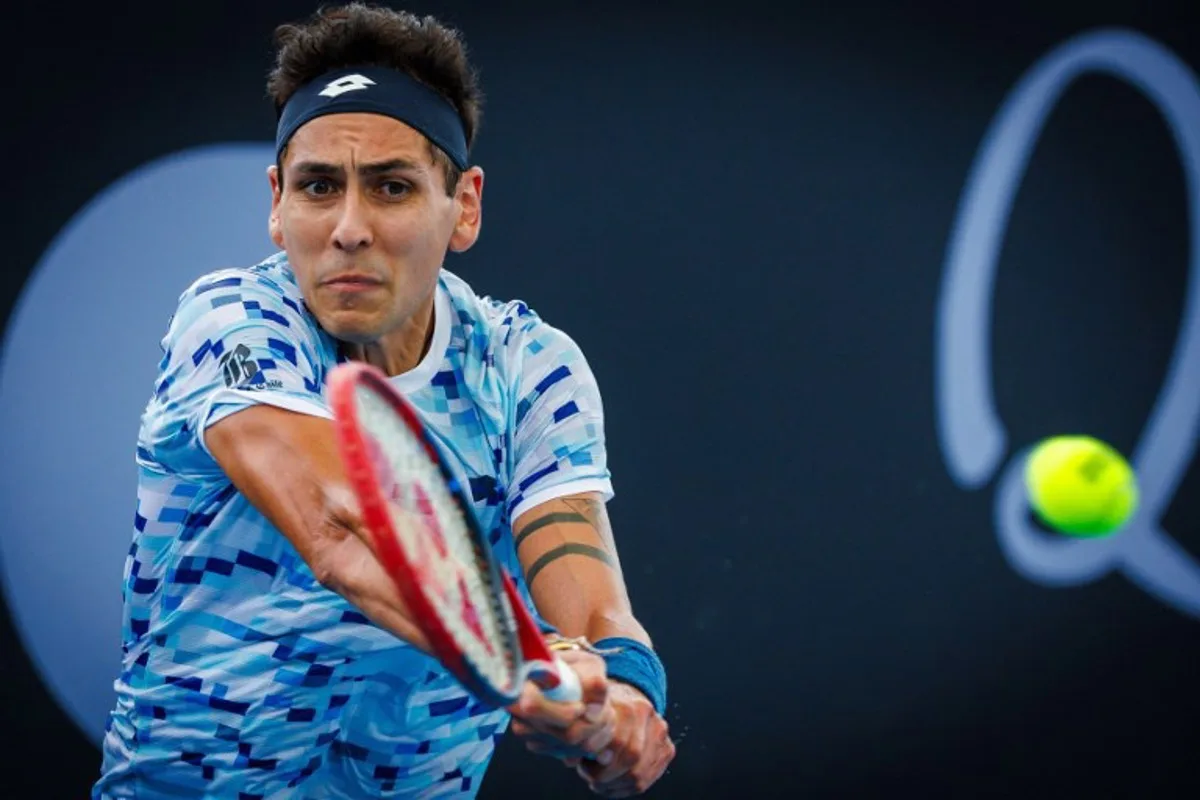 Chile's Alejandro Tabilo hits a return against France's Benjamin Bonzi during their men's singles match at the Brisbane International tennis tournament in Brisbane on December 30, 2024.  Patrick HAMILTON / AFP