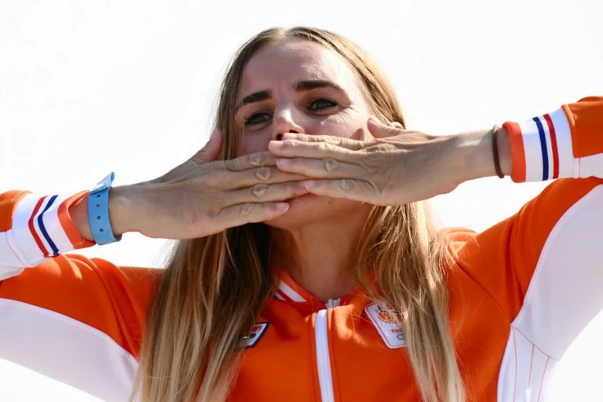 Gold medallist Netherlands' Marit Bouwmeester celebrates on the podium during the award ceremony for the women's ILCA 6 single-handed dinghy event during the Paris 2024 Olympic Games sailing competition at the Roucas-Blanc Marina in Marseille on August 7, 2024. Christophe SIMON / AFP