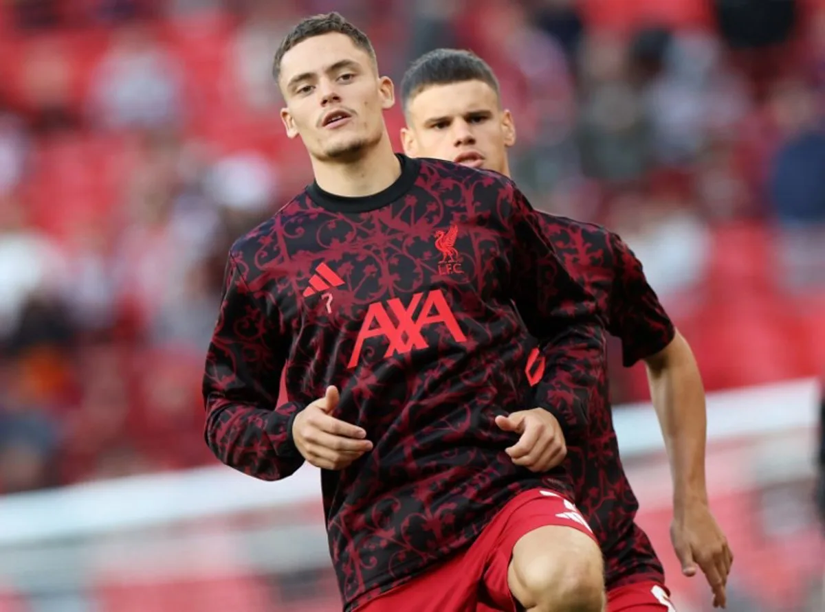Liverpool's German midfielder #07 Florian Wirtz (L) and Liverpool's Hungarian defender #06 Milos Kerkez warm up ahead of the second of two pre season friendly football matches between Liverpool and Athletic Bilbao at Anfield in Liverpool, north west England on August 4, 2025. Darren Staples / AFP