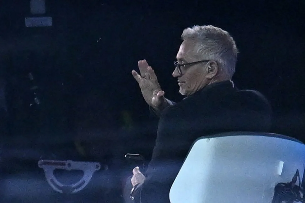 BBC TV presenter Gary Lineker gestures to a well-wisher from the studio ahead of kick-off in the English FA Cup quarter-final football match between Manchester City and Burnley at the Etihad Stadium in Manchester, north-west England, on March 18, 2023.  Oli SCARFF / AFP