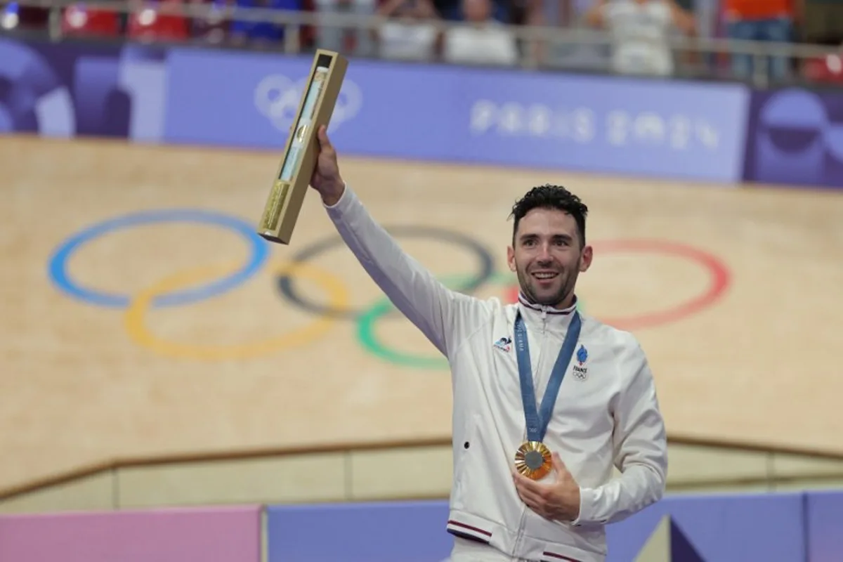 Gold medallist France's Benjamin Thomas poses  on the podium of the men's track cycling omnium event of the Paris 2024 Olympic Games at the Saint-Quentin-en-Yvelines National Velodrome in Montigny-le-Bretonneux, south-west of Paris, on August 8, 2024.  Thomas SAMSON / AFP