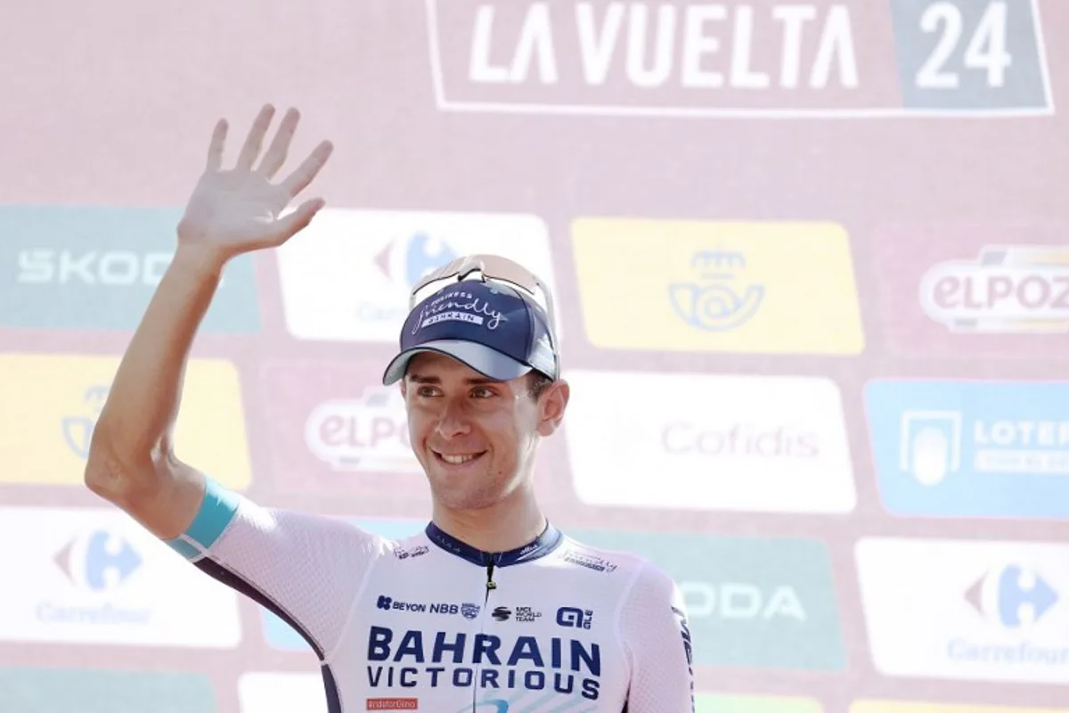 Team Bahrain's Antonio Tiberi celebrates on the podium retaining the youth ranking leader's white jersey after the stage 8 of La Vuelta a Espana cylcing tour, a 159 km race between Ubeda and Cazorla, on August 24, 2024.    Jorge GUERRERO / AFP