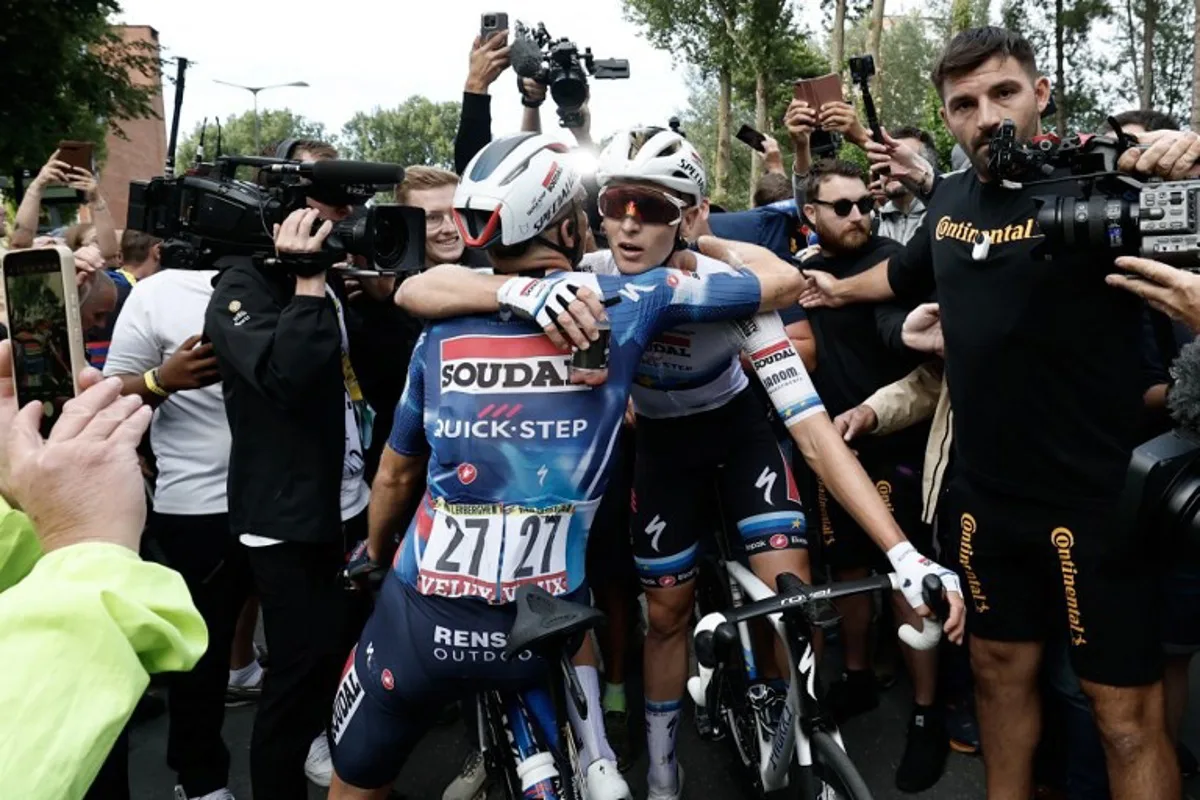 Soudal Quick-Step team's Belgian rider Tim Merlier celebrates with Soudal Quick-Step team's Belgian rider Bert Van Lerberghe after winning the 3rd stage of the 112th edition of the Tour de France cycling race, 178.3 km between Valenciennes and Dunkerque (Dunkirk), Northern France, on July 7, 2025. BENOIT TESSIER / POOL / AFP