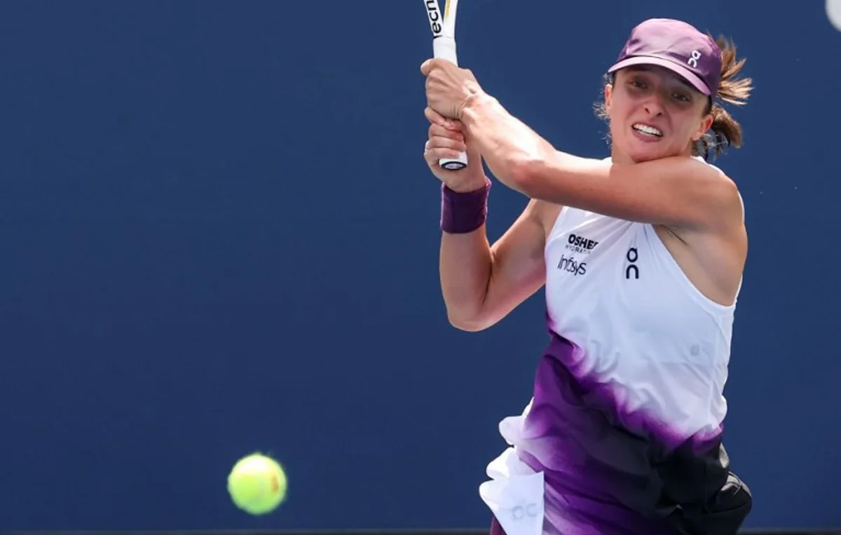 Poland's Iga Swiatek hits a return to Argentina's Nadia Podoroska during their women's singles second round tennis match on day five of the US Open tennis tournament at the USTA Billie Jean King National Tennis Center in New York City on September 3, 2026.  TIMOTHY A. CLARY / AFP