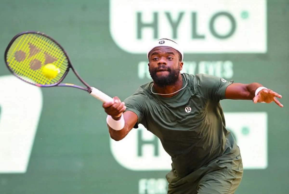 Frances Tiafoe of the US returns the ball to his compatriot Taylor Fritz during the men's singles final match of the Halle Open ATP tennis tournament in Halle, western Germany, on June 21, 2026. CARMEN JASPERSEN / AFP