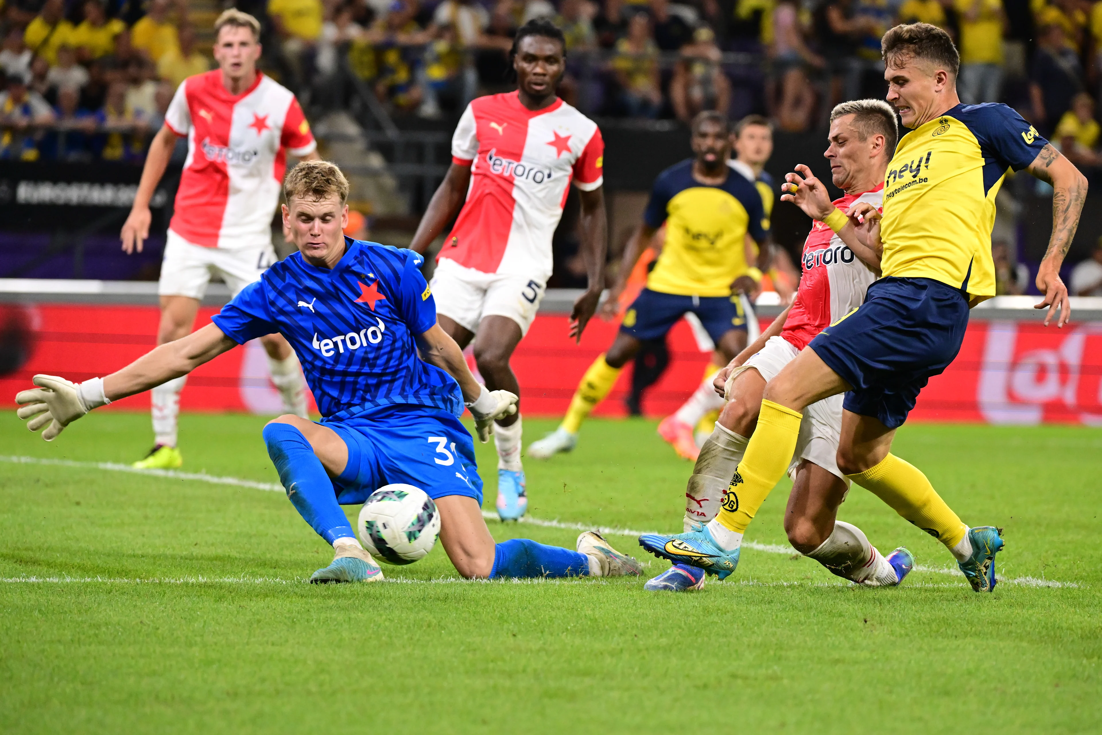 Slavia Prague's Antonin Kinsky and Union's Dennis Eckert Ayensa fight for the ball during a soccer game between Belgian Royale Union Saint-Gilloise and Czech SK Slavia Praha, on Tuesday 13 August 2024 in Anderlecht, Brussels, the return leg of the third qualifying round for the UEFA Champions League competition. Praha won the first leg 3-1. BELGA PHOTO LAURIE DIEFFEMBACQ