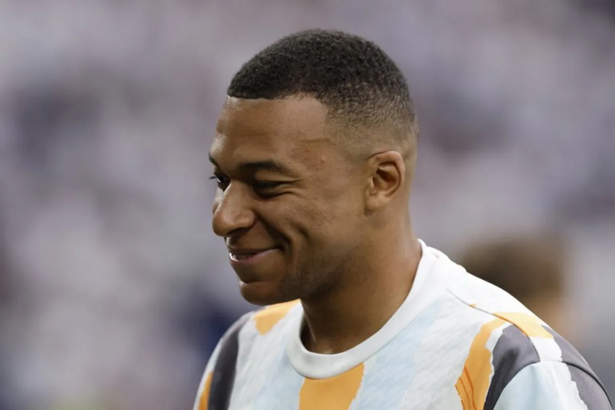 Real Madrid's French forward #09 Kylian Mbappe smiles prior to the Spanish league football match between Real Madrid CF and Real Sociedad at Santiago Bernabeu Stadium in Madrid on May 24, 2025. OSCAR DEL POZO / AFP