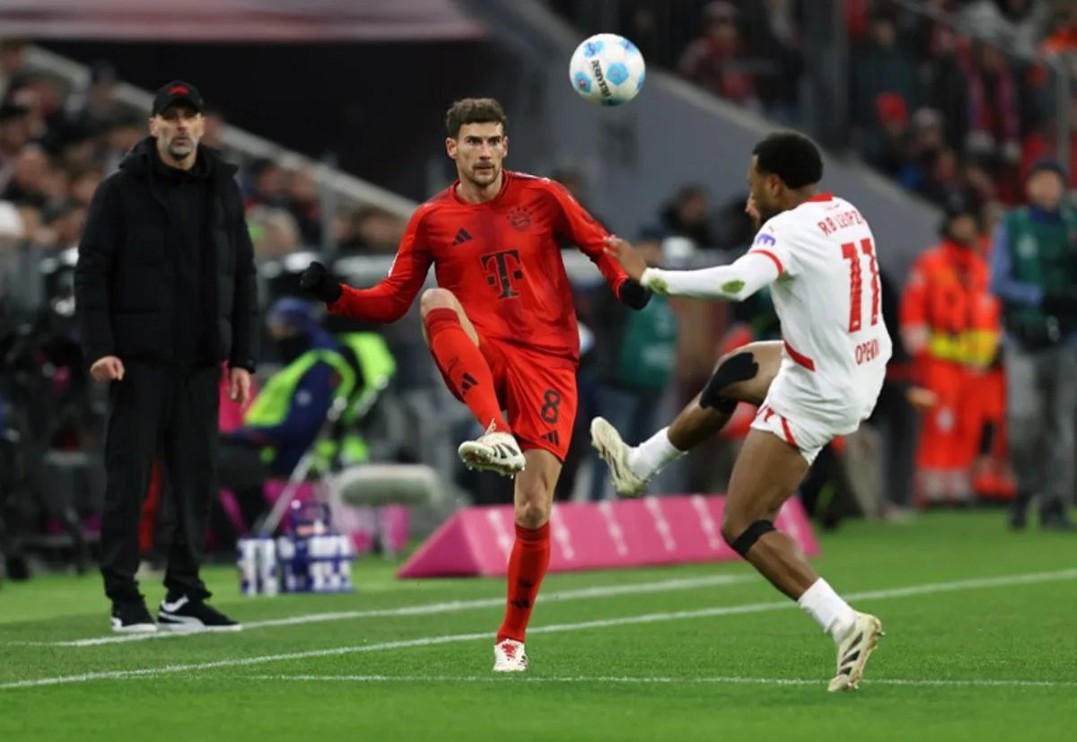 Bayern Munich's German midfielder #08 Leon Goretzka (L) and Leipzig's Belgian forward #11 Lois Openda vie for the ball during the German first division Bundesliga football match between FC Bayern Munich and RB Leipzig in Munich, southern Germany, on December 20, 2024.  Alexandra BEIER / AFP