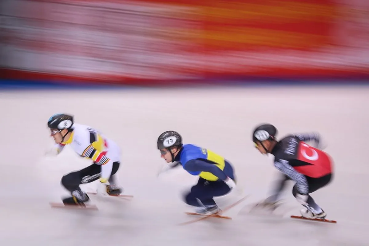 Stijn Desmet #08 of Belgium, Oleh Handei #75 of Ukraine and Murat Tahtaci #141 of Tuerkiye compete during the men's 500m heat on Day 1 of the ISU European short track speed skating Championships in Dresden, eastern Germany, on January 17, 2025.  Ronny HARTMANN / AFP