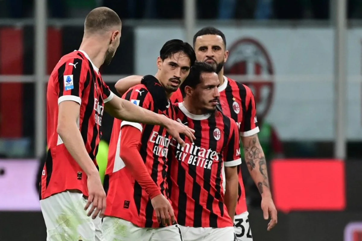 AC Milan's Dutch midfielder #14 Tijani Reijnders (C) celebrates with teammates after scoring his team's first goal during the Italian Serie A football match between AC Milan and Inter at San Siro stadium in Milan, on February 2, 2025.  PIERO CRUCIATTI / AFP