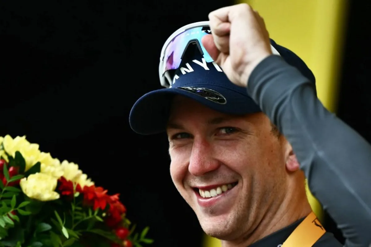Alpecin - Deceuninck team's Australian rider Kaden Groves celebrates on the podium after winning the 20th stage of the 112th edition of the Tour de France cycling race, 184.2 km between Nantua and Pontarlier, in the Jura, eastern France, on July 26, 2025.  Marco BERTORELLO / AFP