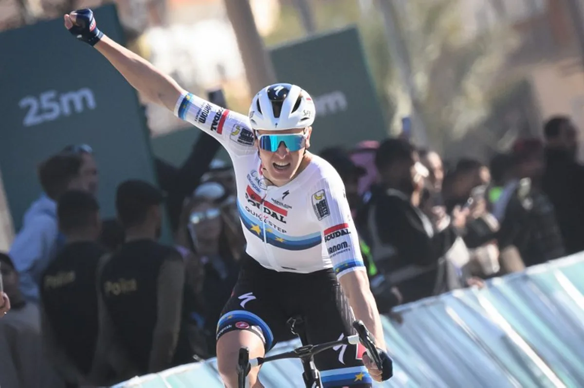 Team Soudal Quick-Step Belgian rider Tim Merlier celebrates while crossing the finish line to win the third stage of the AlUla Tour cycling race, from Hegra to Tayma Fort on January 30, 2025.  Loic VENANCE / AFP