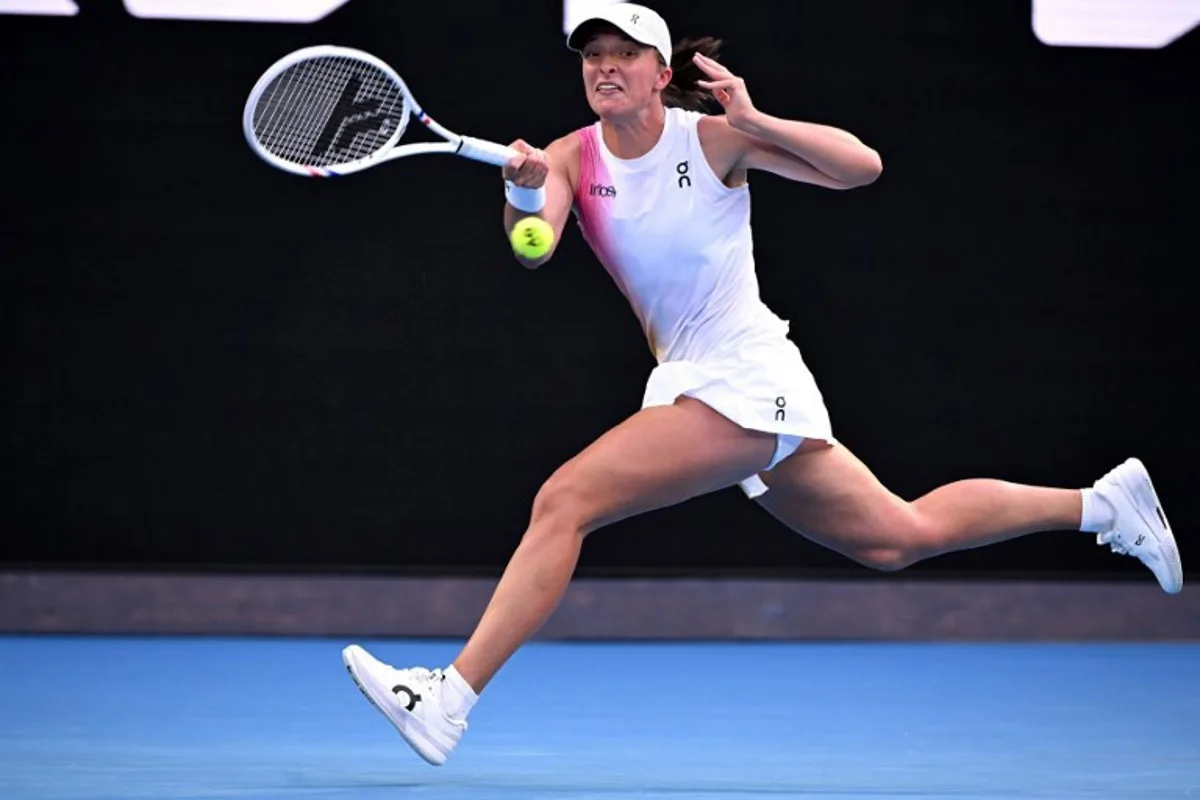 Poland's Iga Swiatek hits a return against Germany's Eva Lys during their women's singles match on day nine of the Australian Open tennis tournament in Melbourne on January 20, 2025.  WILLIAM WEST / AFP