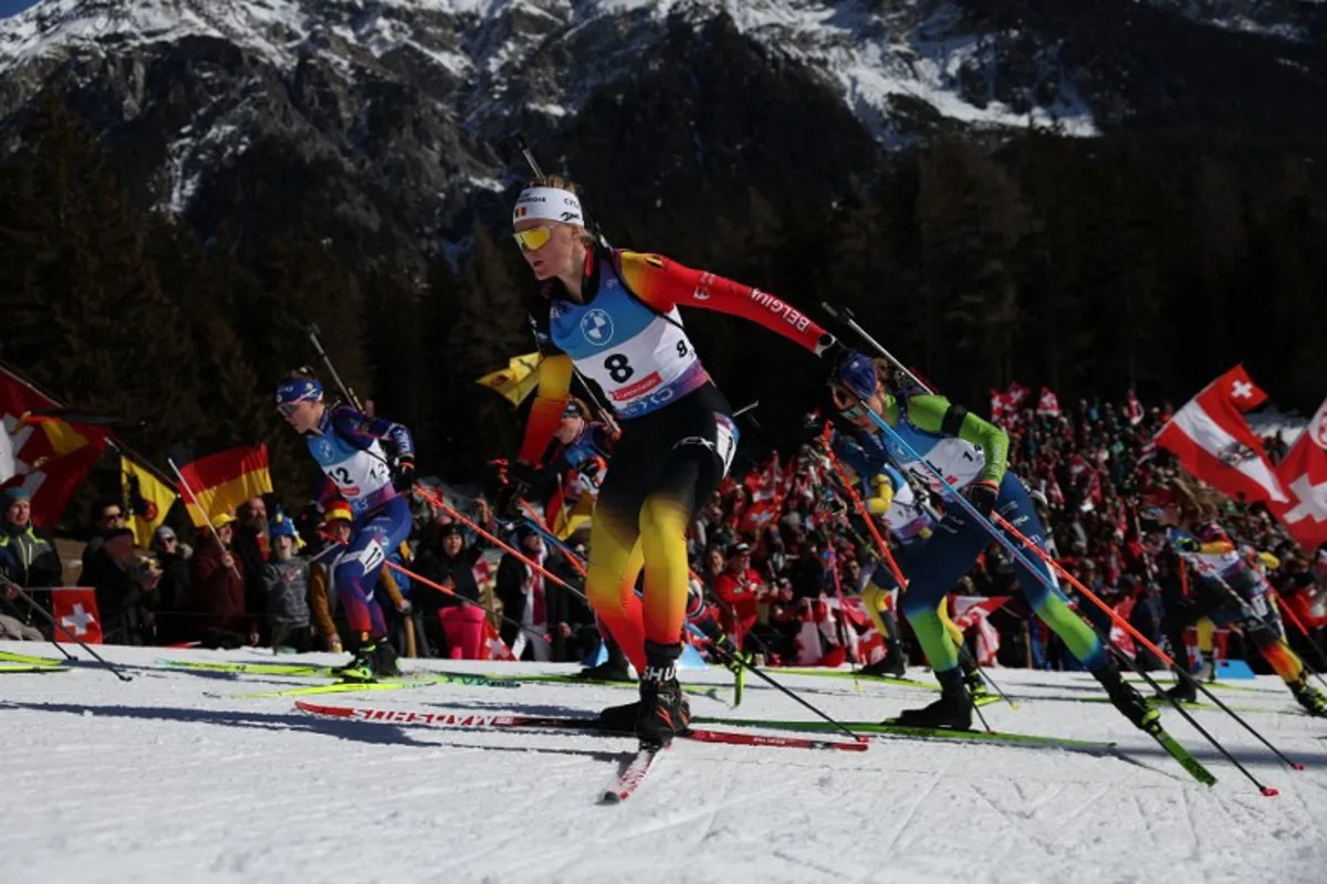 France's Oceane Michelon (L), Belgium's Maya Cloetens (C) and Slovenia's Anamarija Lampic (R) compete during the Women 10 km Pursuit event of the IBU Biathlon World Championship of Lenzerheide, eastern Switzerland, on February 16, 2025.  FRANCK FIFE / AFP