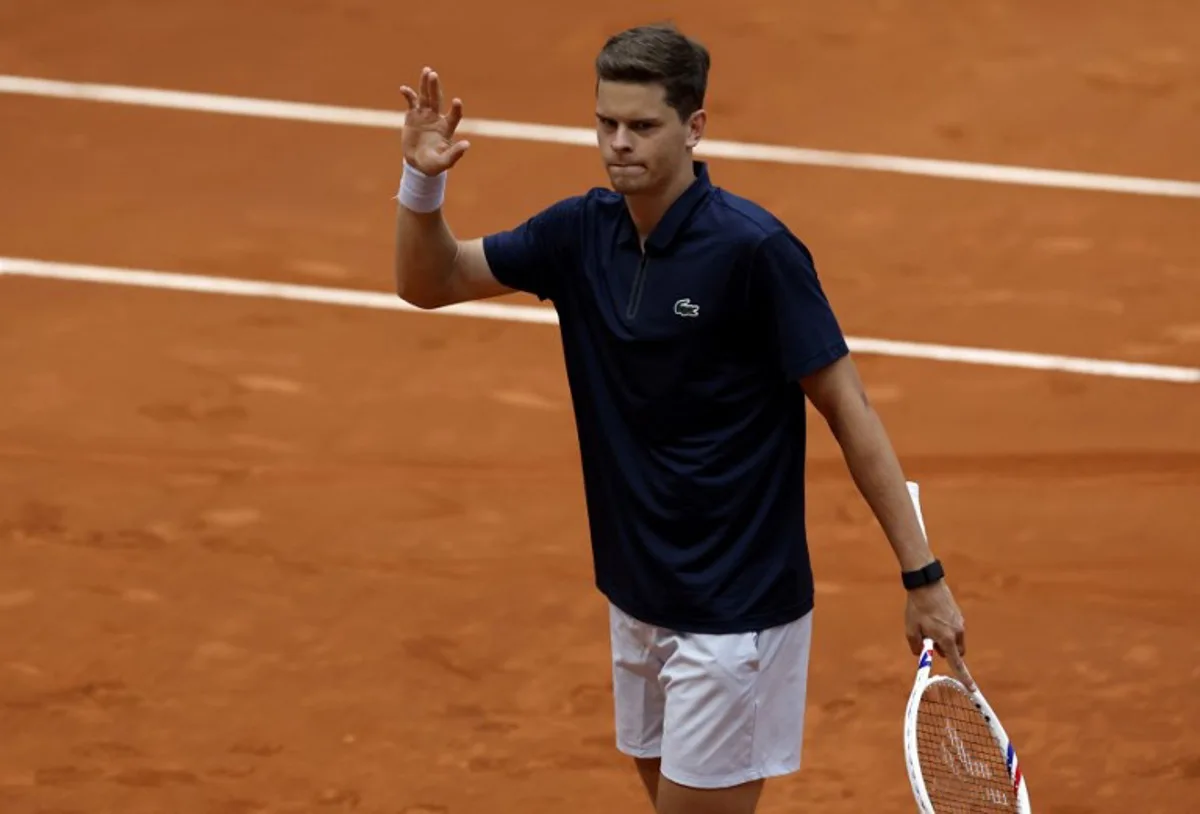 Belgium's Alexander Blockx celebrates after winning the 2026 ATP Tour Madrid Open tennis tournament third round singles tennis match against Canada's Felix Auger-Aliassime at the Caja Magica in Madrid, on April 27, 2026.  OSCAR DEL POZO / AFP