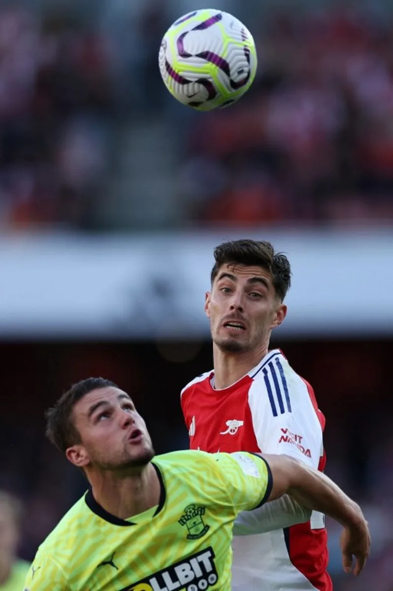 Southampton's English defender #06 Taylor Harwood-Bellis vies with Arsenal's German midfielder #29 Kai Havertz during the English Premier League football match between Arsenal and Southampton at the Emirates Stadium in London on October 5, 2024.   Adrian Dennis / AFP