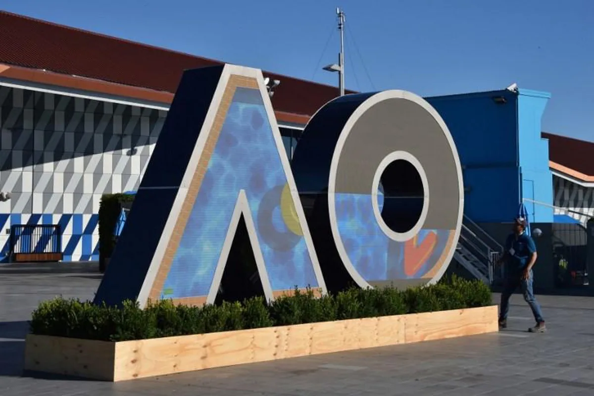 A worker checks on a logo for the Australian Open tennis tournament ahead of its start in Melbourne on January 14, 2018.  PETER PARKS / AFP -- IMAGE RESTRICTED TO EDITORIAL USE - STRICTLY NO COMMERCIAL USE --

