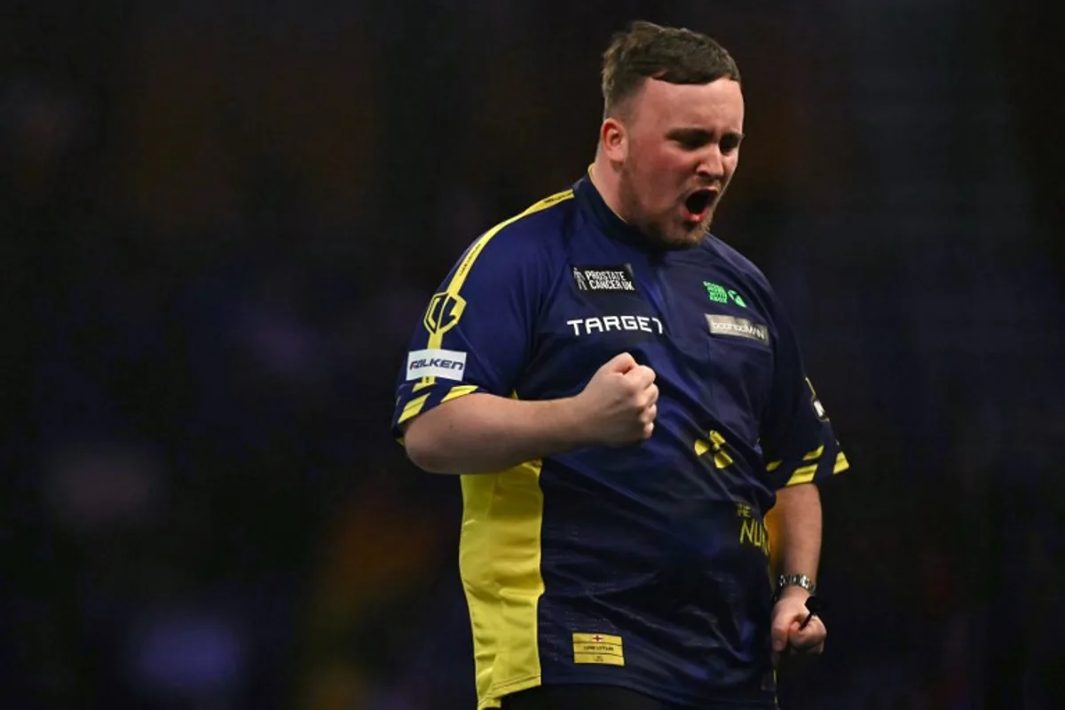 England's Luke Littler celebrates winning the fourth set against Netherlands' Michael van Gerwen during the PDC World Darts Championship final, at Alexandra Palace in London on January 3, 2025.  Ben STANSALL / AFP