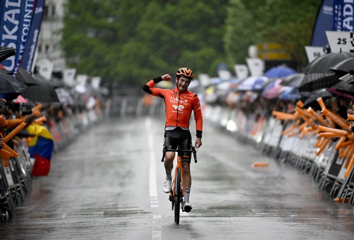 Team Ineos' US rider AJ August celebrates winning the sixth and last stage of the Basque Country's Itzulia cycling tour, a 135.4 km race between Goizper-Antzuola and Bergara, on April 11, 2026. ANDER GILLENEA / AFP