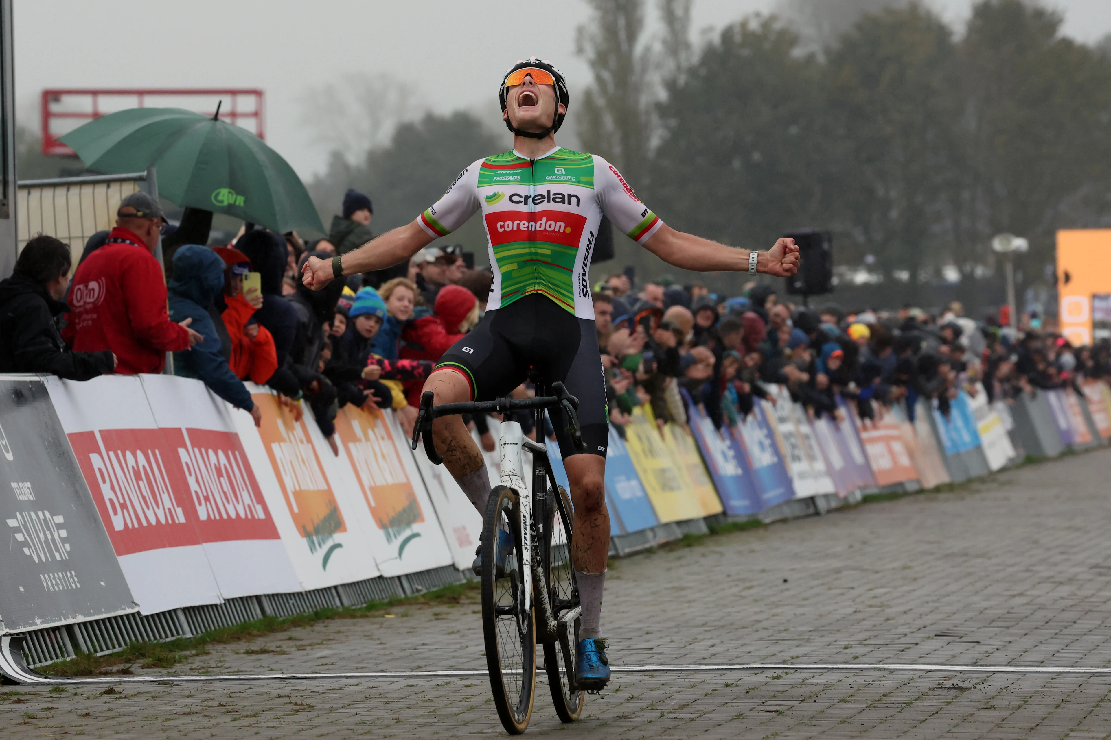 Belgian Joran Wyseure celebrates as he crosses the finish line to win the men elite race of the Cyclocross Ruddervoorde, Sunday 20 October 2024 in Oostkamp, the first stage of the Superprestige cyclocross cycling competition. BELGA PHOTO KURT DESPLENTER