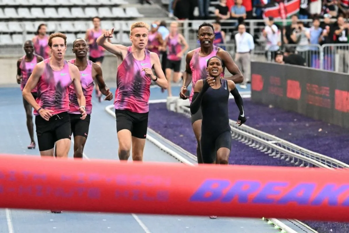 Kenya's Faith Kipyegon (R) takes part in the "Breaking4" event, in an attempt to become the first woman to run a mile in under four minutes, at Stade Charlety on June 26, 2025 in Paris. Triple Olympic champion Faith Kipyegon of Kenya fell well short in her bid to become the first woman to run a sub-four minute mile on June 26. Aided by wavelength technology and 13 pacers, 11 male and two women, Kipyegon clocked 4min 06.42sec over 1.6km in perfect conditions. EMMA DA SILVA / AFP