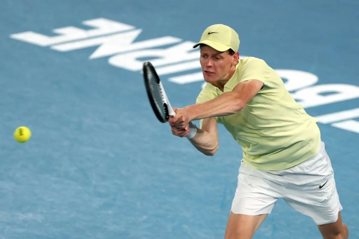 Italy's Jannik Sinner hits a shot against USA's Ben Shelton during their men's singles semi-final match on day thirteen of the Australian Open tennis tournament in Melbourne on January 24, 2025.  Adrian Dennis / AFP